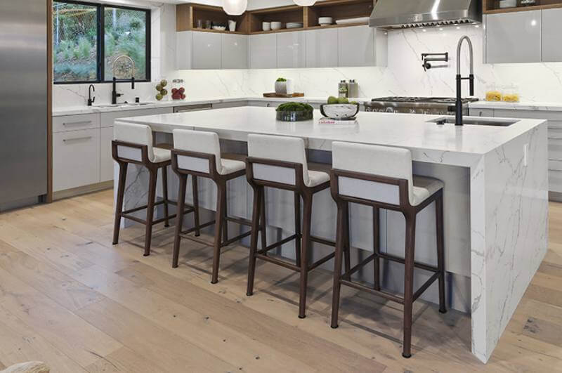 Kitchen with white island and wood floors