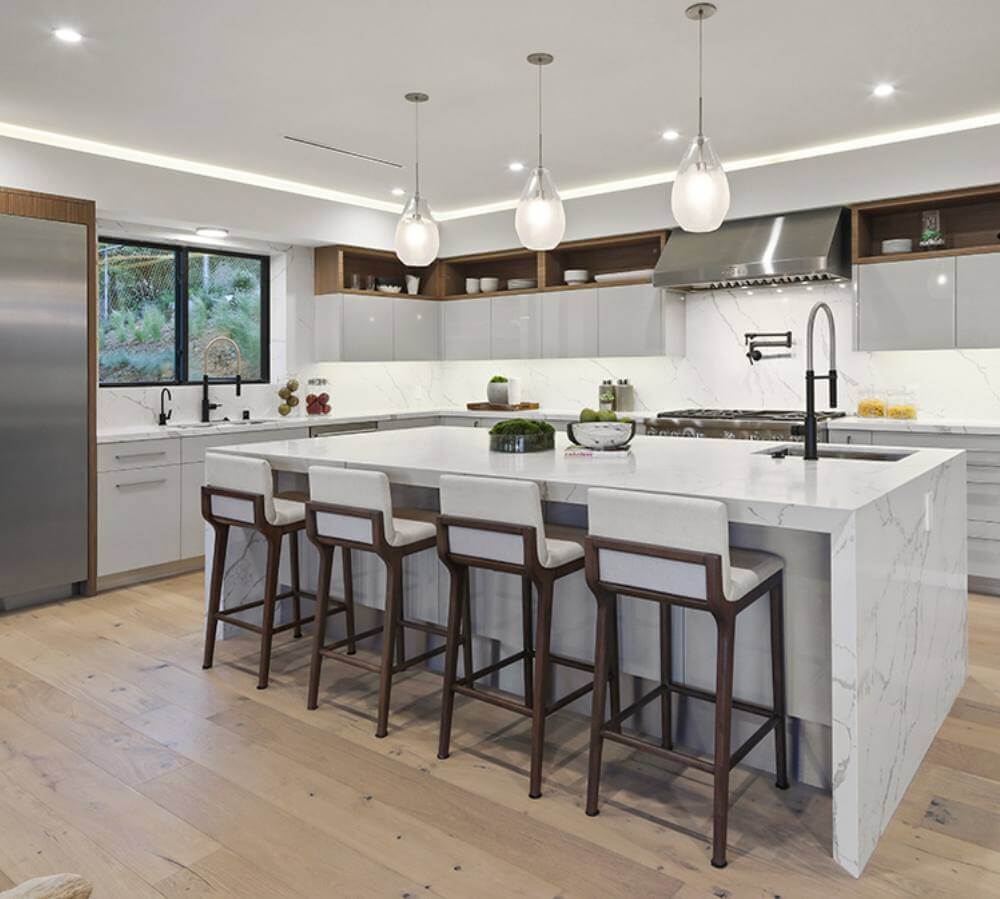 Kitchen with white island and wood floors